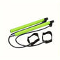Green exercise poles with black straps on a white background