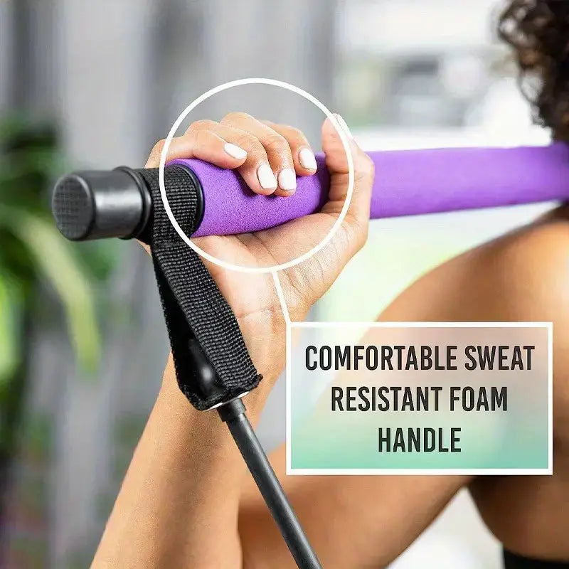 Hand holding a purple foam roller with text 'Comfortable sweat resistant foam handle' on a blurred background